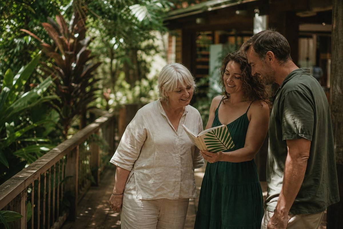 A client with two Kuranda Village Accountancy team members on the office deck